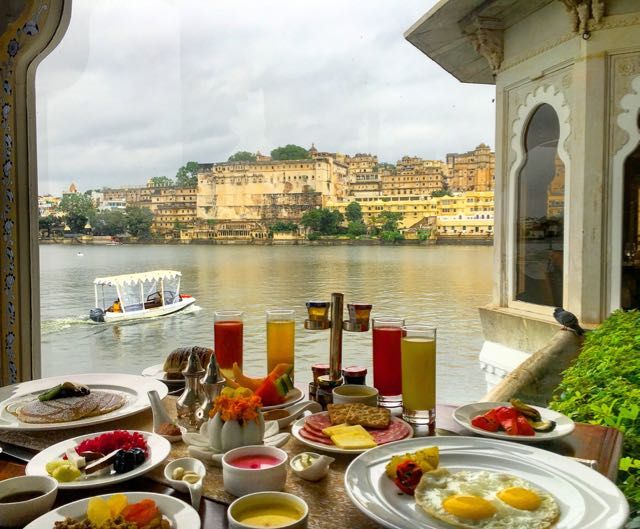 Lakeside breakfast spread with a view of a royal Indian palace — culinary journeys with Travel Ocean